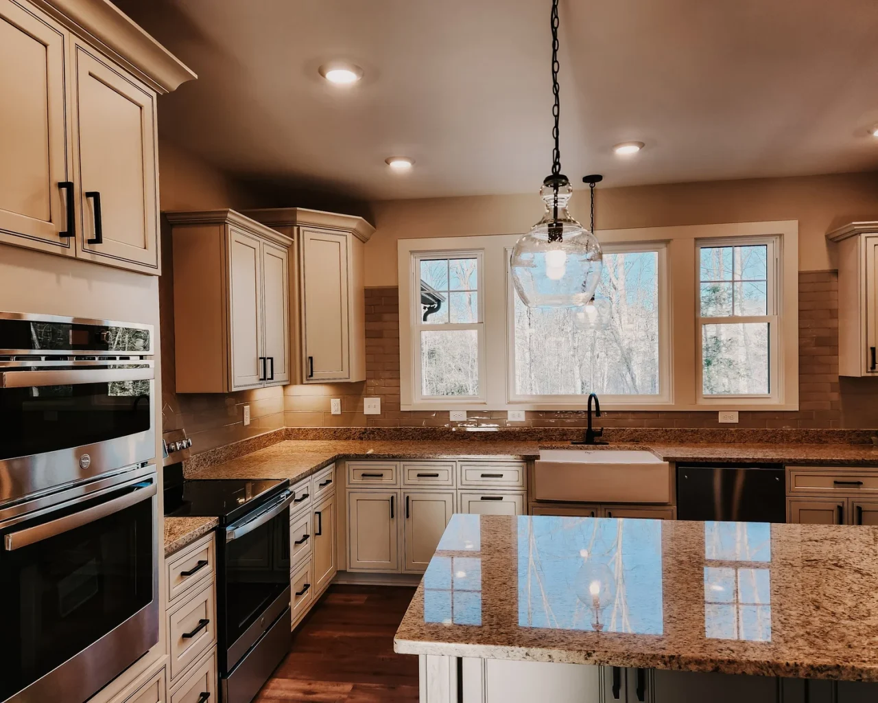 Spacious kitchen in Pauline Country Home, featuring granite countertops, modern appliances, and large windows.