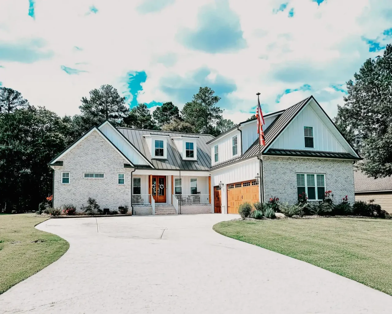 Modern Pauline country home with metal roof, flag, and curved driveway, showcasing your vision at Lake Greenwood.