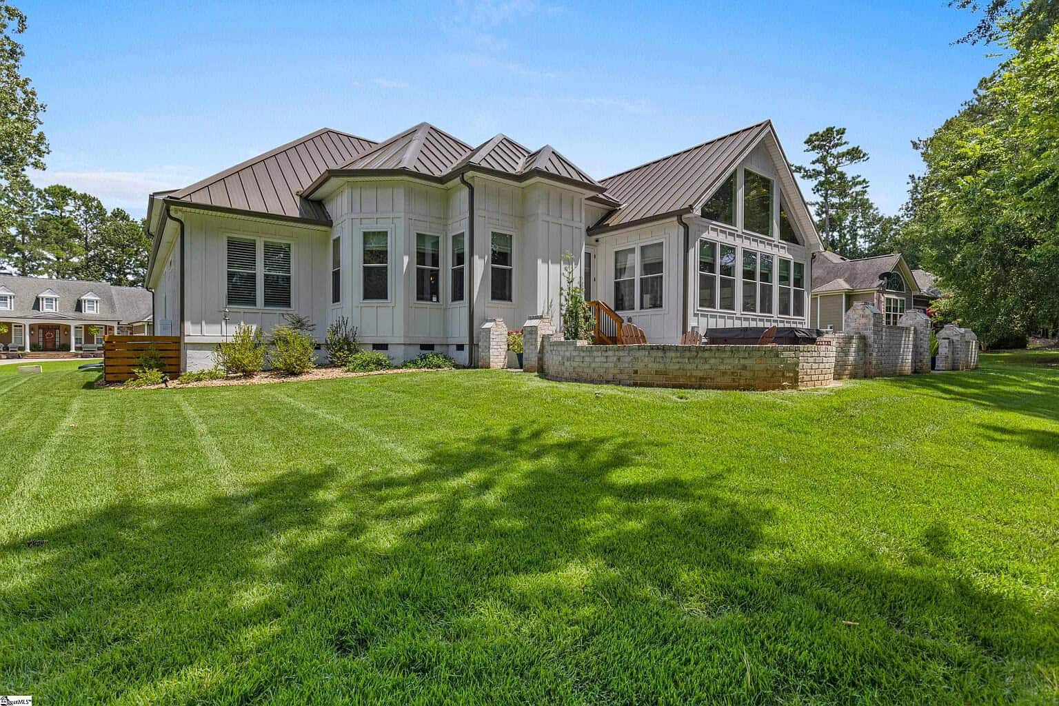 Modern custom home with manicured lawn, showcasing craftsmanship and integrity by Josh Timms Builders.