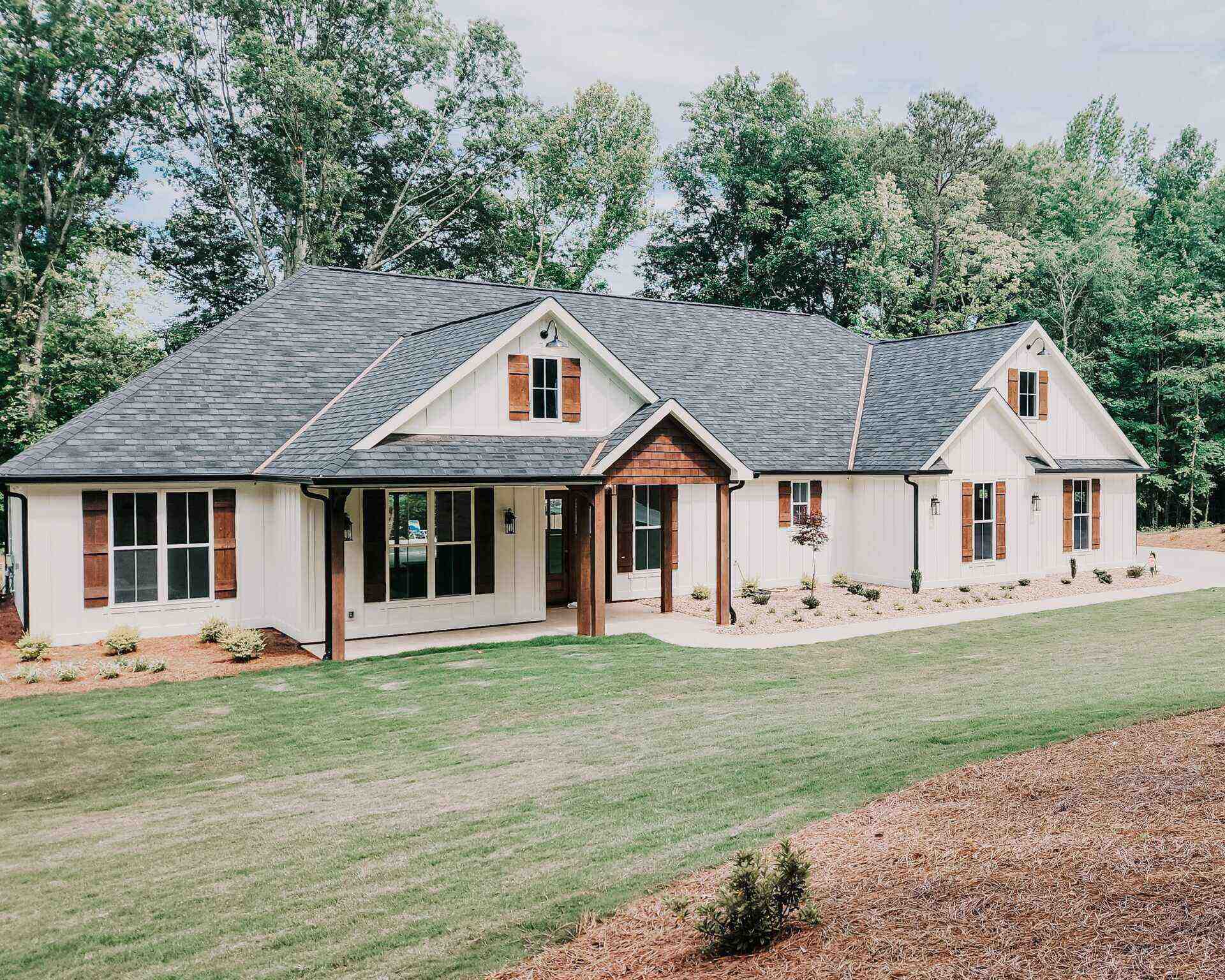 Custom built home by Josh Timms Builders, showcasing a higher standard in homebuilding amidst lush greenery.
