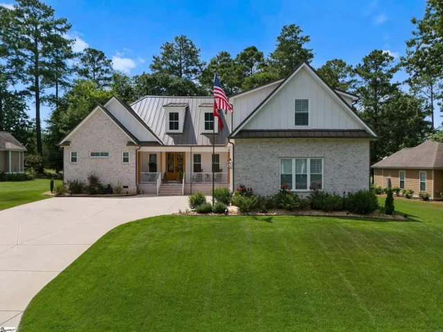 Custom home with brick exterior and landscaped yard on your land upstate, showcasing dream home potential.